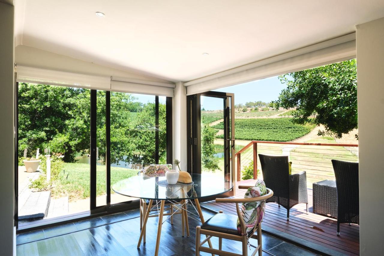 Alluvia Boutique Winery & Luxury Accommodation Stellenbosch Exterior photo A room with a view of the vineyards