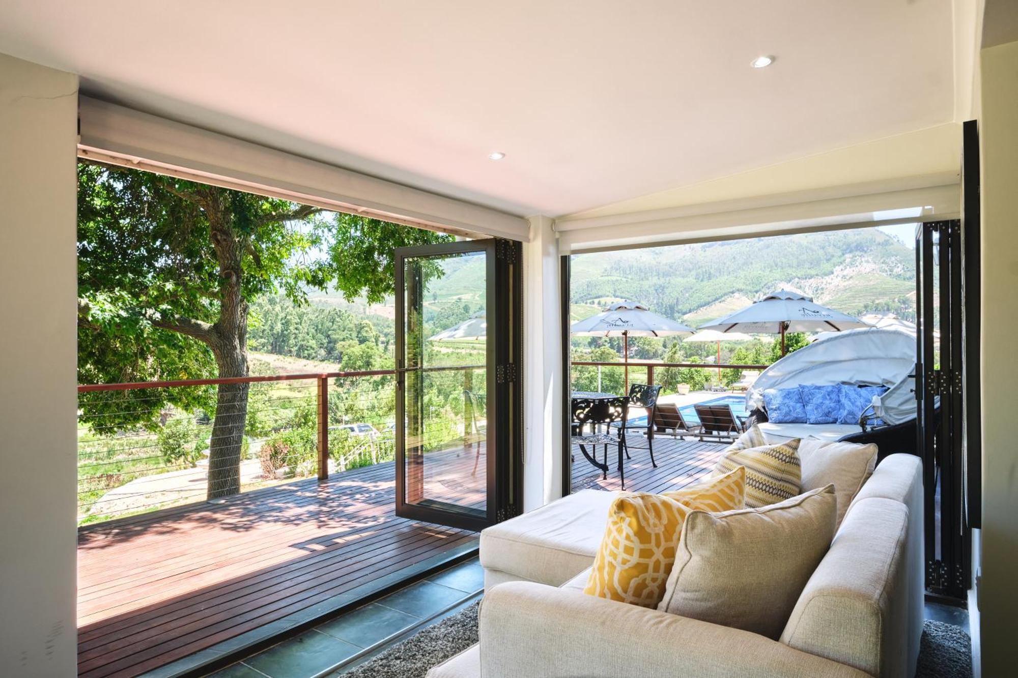 Alluvia Boutique Winery & Luxury Accommodation Stellenbosch Room photo A living room with a view of the vineyard